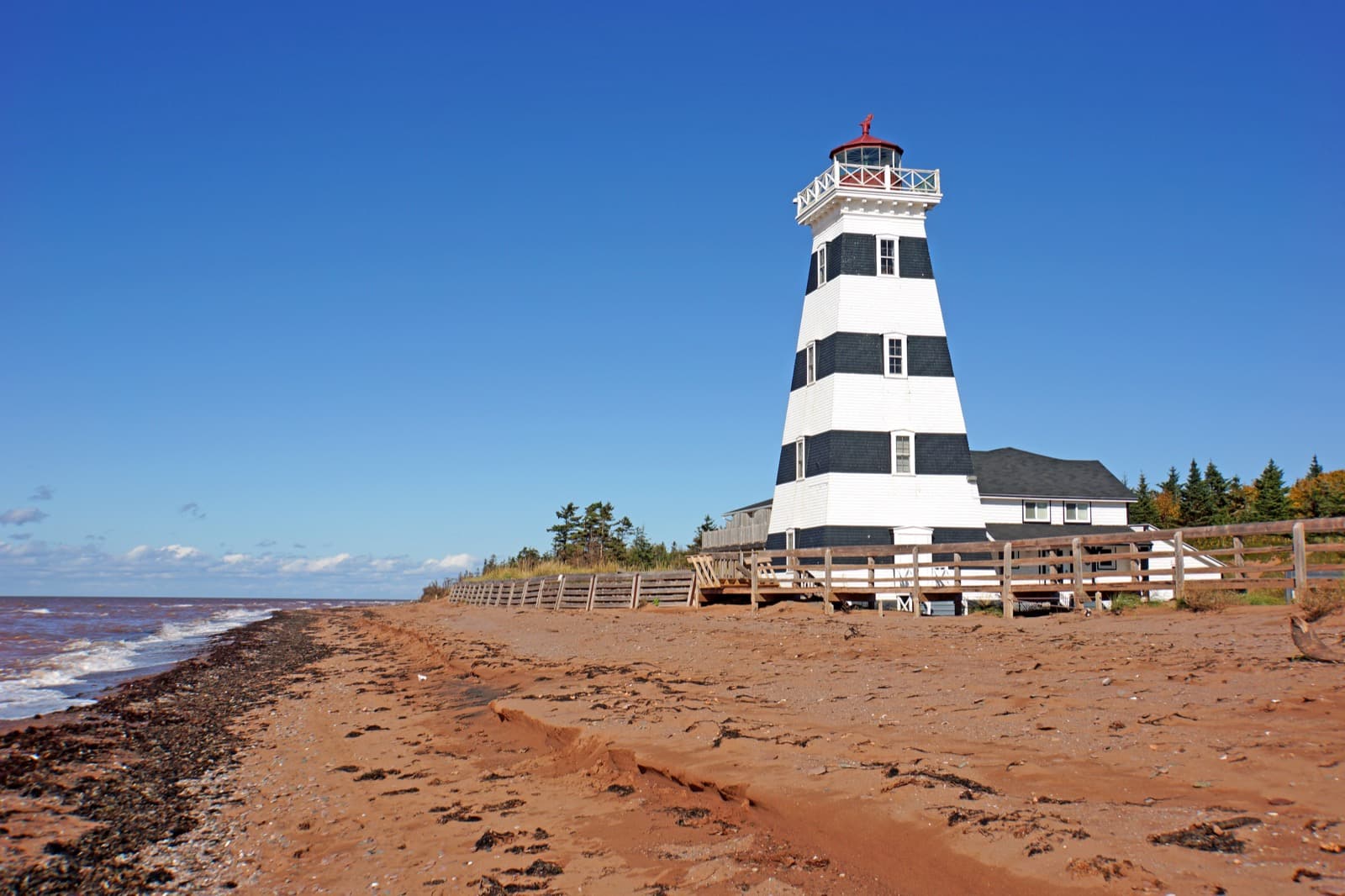 The candy-striped West Point lighthouse on Prince Edward Island's red-sand beach