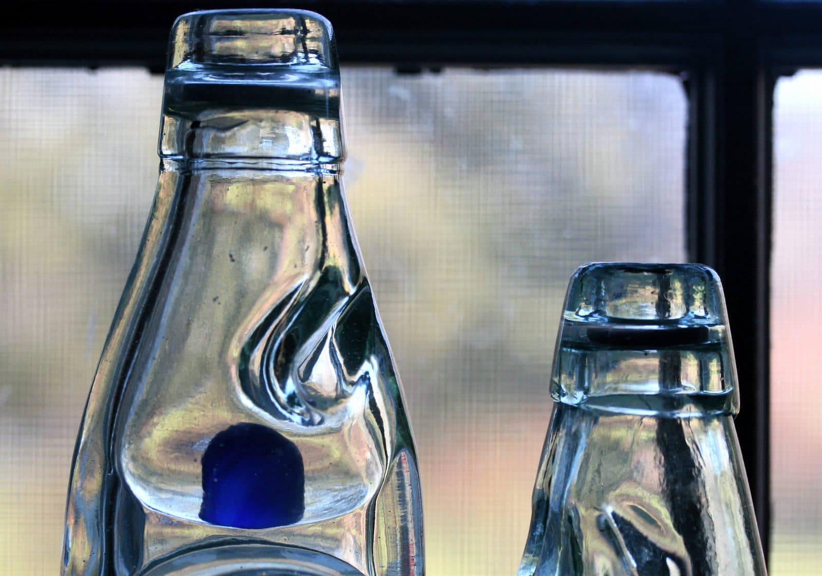 Codd-neck soda bottles with their glass marbles
