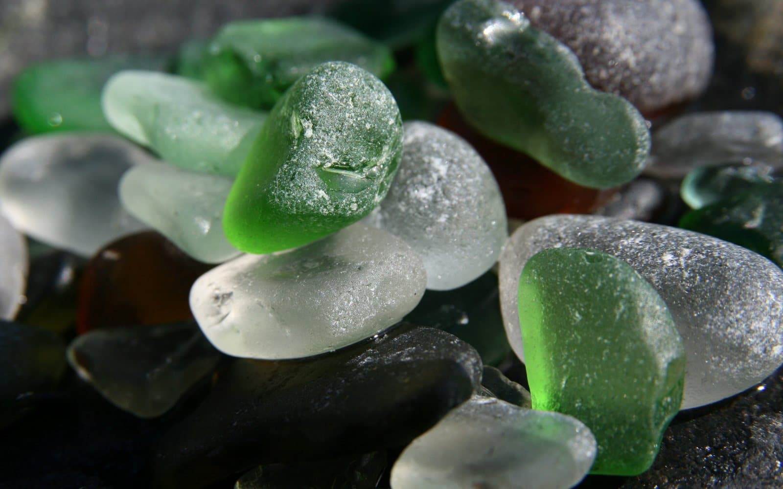 Frosted sea glass tumbled smooth on a British beach