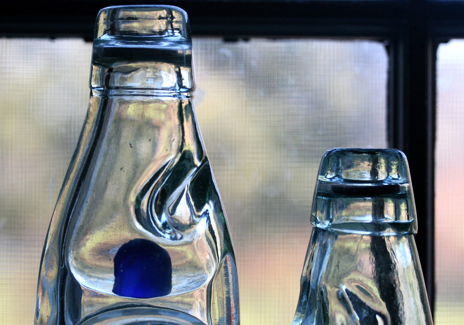 Codd-neck soda bottles with their glass marbles