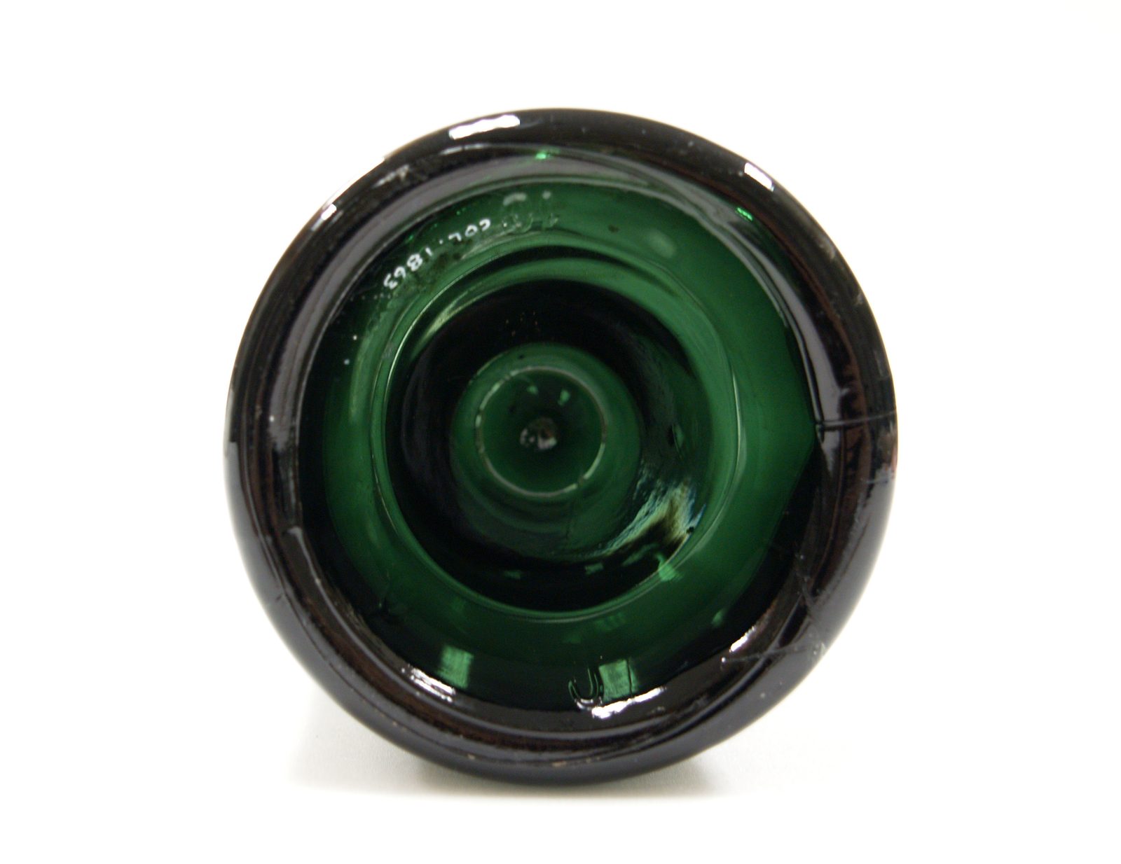 The base of an antique green bottle with a deep kick-up
